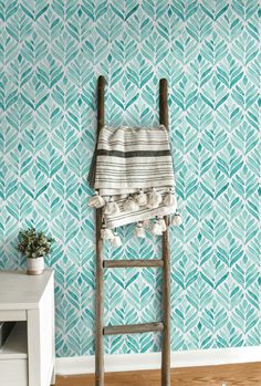 a ladder in front of a blue wallpaper