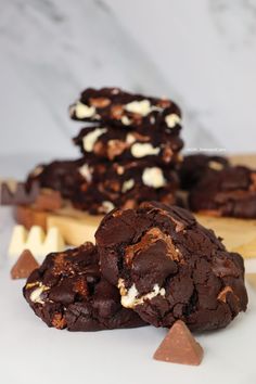 chocolate cookies and marshmallows are stacked on top of each other