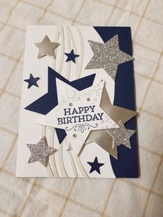 a birthday card with stars on it and the words happy birthday written in silver foil