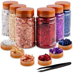 six jars filled with different colored glitters next to a pair of scissors