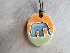 a ceramic elephant ornament hanging on a string