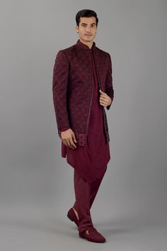 Wine jacquard Jodhpuri style jacket with mandarin collar, layered panel, all over geometric pattern, thread and cut dana embroidery. Paired with kurta with side cascading overlap panel and trouser.
Components: 3
Pattern: Embroidered
Type Of Work: Thread and Cut Dana Work
Neckline: Jacket: Mandarin Collar, Kurta: Band Collar
Sleeve Type: Full Sleeves
Fabric: Terry Rayon
Color: Wine
Other Details: 
Asymmetric kurta hem
Layered jacket
Kurta Closure: Shoulder concealed zip
Occasion: Destination Wedd Traditional Fall Sherwani For Formal Occasions, Traditional Fall Formal Sherwani, Traditional Embroidered Semi-formal Outerwear, Traditional Semi-formal Winter Outerwear, Traditional Semi-formal Outerwear With Stand Collar, Formal Winter Outerwear With Traditional Drape, Traditional Semi-formal Nehru Jacket For Fall, Traditional Semi-formal Fall Nehru Jacket, Traditional Long Sleeve Burgundy Sets