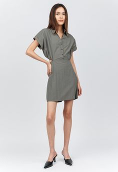 One size. Fits XS-M Color: Green Gray 100% Nylon Folded Short Sleeve Dress Mini Length One Size Collared V-Neck Button-Down Detailing Open-Back Elastic Waist Lightweight Water-Resistant Material Dry Clean or Hand Wash Separately By The NKC Store. Product Measurements: Shoulders: 40.64cm / 16in Bust: 101.6cm / 40in Waist: 104.14cm / 41in Length: 78.74cm / 31in Model is 167cm/ 5'6" wearing Size O/S Dallas Fashion, Contemporary Dresses, Dress Store, Dress Mini, Engineered Garments, Short Sleeve Dress, Leisure Wear, Green Dress, Sleeve Dress