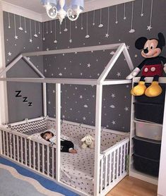 an image of a child's bedroom with mickey mouse on the wall