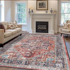 a living room filled with furniture and a rug on top of a hard wood floor