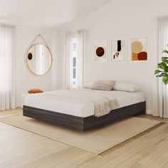 a bedroom with white walls and wooden floors