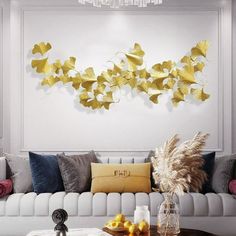 a living room filled with furniture and lots of yellow butterflies on the wall above it