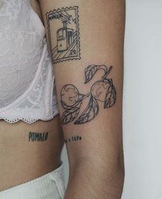 a woman's arm with tattoos on it