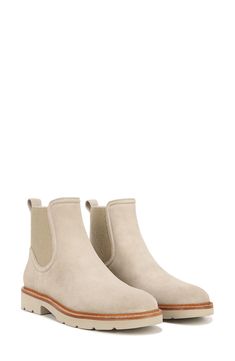 Soft suede wraps the upper of a streamlined Chelsea boot with a gore insets and an easy-on pull tab for effortless grab-and-go comfort. 1" heel (size 8.5) 5" shaft Leather upper and lining/rubber sole Imported