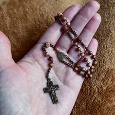 Old vintage Catholic Rosary beads, handmade, sourced from Vienna.  📿Small pink/brown beads, hand carved decorative consecutive beads.  📿Brass coloured metal crucifix with black inlay.  As this rosary is antique/vintage, the beads and metal will show signs of age, such as rust and discolouration. I have chosen not to clean or polish the rosaries, as I feel the aging adds to the aesthetic. Free UK postage for orders over £20. Any questions, drop me a message ❤️🔥 Vintage Cross Jewelry With 8mm Beads, Beaded Brown Rosary Gift, Brown Beaded Rosary Gift, Brown Beaded Rosary As Gift, Vintage Bronze Rosary As Gift, Vintage Rosary With Cross Pendant Gift, Handmade Brown Crucifix Jewelry, Handmade Brown Spiritual Rosary, Antique Handmade Rosary As Gift