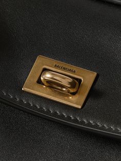 Find BALENCIAGA Rodeo Mini Leather Tote on Editorialist. The Balenciaga Rodeo tote is crafted from soft leather and features gold-tone hardware. The bag has a detachable shoulder strap, a top handle, and a turn lock closure. The interior has multiple compartments and is large enough to carry a cardholder, phone, and keys. It is a mini bag. High-end Gold Shoulder Bag For Everyday, Luxury Gold Bag For Business, Luxury Gold Business Bag, Gold Calf Leather Bag With Gold-tone Hardware, Luxury Gold Calf Leather Shoulder Bag, Designer Gold Shoulder Bag With Brass Hardware, Designer Gold Shoulder Bag For Work, Yellow Gold Rectangular Leather Bag, Gold Leather Shoulder Bag With Metal Hardware