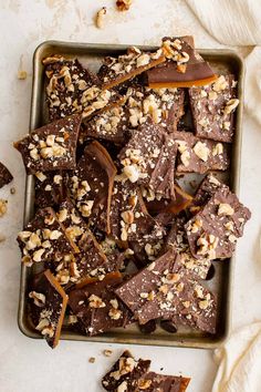 a tray filled with chocolate and nuts on top of a table