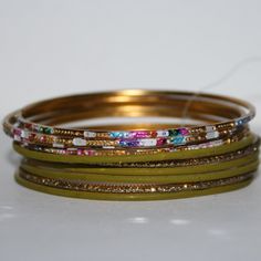 This Is A Beautiful Bangle Set. It Still Has The Plastic Tag Holding The Set Together. The Bangles Equal 1 Inch Tall And They Are 2.5 Inches Wide Across. Add At Least Five Items In Your Bundle And Receive A Special Offer 50% Off Original Bundle Price! Buy From Me With Confidence! I Have Sold Over 9000 Items With A 5 Star Rating! I Ship Quickly! Just Comment In The Bundle Saying You Are Done Yellow Metal Bangle Bracelet, Green Metal Bracelets For Festive Occasions, Yellow Metal Bracelets For Party, Clock Necklace, Rose Gold Bangle Bracelet, Colorful Bangles, Over 9000, Black Bangle, Beaded Ankle Bracelets