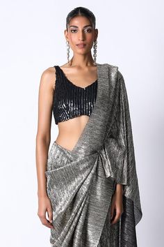 Charcoal and black pre draped metallic saree in a pleated base. Comes with sequin embellished blouse.
Components: 2
Pattern: Textured,Embellished
Type Of Work: Sequin
Neckline: V-neck
Sleeve Type: Sleeveless
Fabric: Silk,Pleated Metallic
Color: Black,Grey
Other Details: 
Built in petticoat
Closure: Saree: Front button
Occasion: Cocktail,Reception - Aza Fashions Elegant Pre-draped Saree With Padded Blouse For Party, Black V-neck Blouse For Party, Fitted V-neck Pre-draped Saree For Party, Black Fitted Pre-draped Saree, Black Blouse With Asymmetrical Neckline For Evening, Black Silk Pre-draped Saree For Party, Black Pre-draped Party Saree, Elegant Black Draped Blouse, Black Party Pre-draped Saree