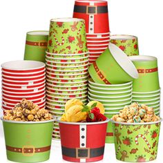 christmas themed cups and plates are stacked on top of each other