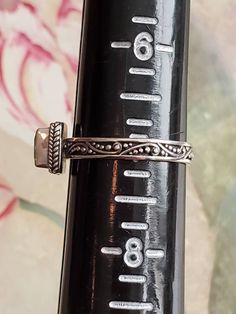 This is a vintage ring with square, faceted, peridot stone and designs on the band. The ring is stamped and has tested positive for sterling silver. There is something on the interior of the band that I can't make out. Sarah, possibly? This is a size 7 and cannot be sized due to the design on the band. Don't forget to stop in at my other Etsy shop... http://www.etsy.com/shop/xtdesigns. Follow me on Twitter at... MyYiayiaHadThat@MyYiayiaHadThat. If you have a wish list or are looking for somethin Adjustable Sterling Silver Ring With Rectangular Stone, Vintage Adjustable Rectangular Ring, Adjustable Rectangular Sterling Silver Ring, Vintage Adjustable Gemstone Stackable Rings, Rectangular Promise Ring Stamped 925, Adjustable Rectangular Engraved Ring For Anniversary, Vintage Silver Ring With Rectangular Stone, Vintage Silver Rings With Rectangular Stone, Win My Heart