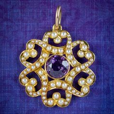 "A pretty antique Victorian pendant made by London jewellers \"Gresham Barber & Co\" in the early 20th century. The piece is fashioned in 15ct gold with a fabulous overlapping design decorated with pearls and a bezel set amethyst in the centre weighing approx. 1.60ct. It's in excellent condition and complete with its original fitted box to store it in with the maker's logo displayed on top. We recommend you insure for £1,600. We can provide a written Valuation on completion of the sale. WEIGHT: Victorian Baroque Yellow Gold Jewelry, Antique Baroque Yellow Gold Jewelry, Heirloom Baroque Jewelry With Historical Design, Art Nouveau Jewelry With Historical Design For Formal Occasions, Art Nouveau Jewelry With Historical Design For Formal Events, Art Nouveau Historical Jewelry For Formal Occasions, Antique Yellow Gold Jewelry With Historical Design, Antique Purple Jewelry For Wedding, Victorian Baroque Collectible Jewelry