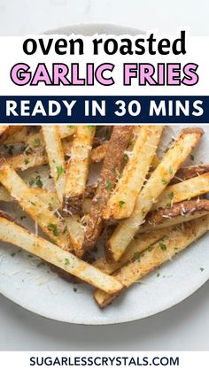 oven roasted garlic fries on a white plate with text overlay that reads oven roasted garlic fries ready in 30 mins