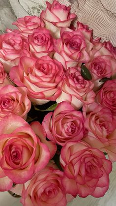 a bunch of pink roses in a vase