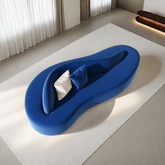 a blue couch sitting on top of a white rug