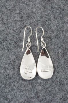 These sterling silver earrings were made by Hopi silversmith Augustine Mowa. The back is stamped sterling.Length: 1 1/2"Width: 1/2"Free shipping on all orders! We ship with USPS and always include tracking. All orders ship within a day of payment.Returns are accepted up to 30 days after you receive your order. Just send us a message. Our shop offers cash back or store credit. The item must be returned in new condition. Polished Sterling Silver Earrings, Sterling Silver Long Drop Jewelry With Polished Finish, Polished Sterling Silver Earrings As A Gift, Hallmarked Sterling Silver Teardrop Jewelry, Silver Sterling Teardrop Earrings With Polished Finish, Sterling Silver Long Drop Earrings As Gift, Silver Teardrop Earrings With Polished Finish For Gift, Engraved Teardrop Sterling Silver Earrings, Gift Long Drop Earrings With Polished Finish