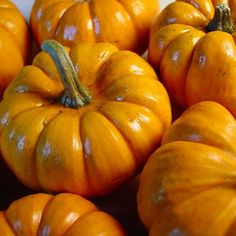 several orange pumpkins are stacked on top of each other