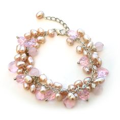 Show off your girly side with our Pink Rose Quartz Cluster Bracelet. This bracelet is made out of clusters of pink synthetic pearls along with touches of pink crystal for a sparkle effect. It is finished off with bits of rose quartz throughout the bracelet. Consider pairing with our Pink Petal Shimmer Necklace for the complete look. The bracelet is 7 inches long with a 2 inch extendable chain. Pink Pearl Bracelet For Party, Pink Pearl Party Bracelet, Party Pink Pearl Bracelet, Elegant Pink Crystal And Pearl Bracelet, Elegant Pink Pearl Crystal Bracelet, Pink Pearl Charm Bracelet, Pink Pearl Beaded Bracelets For Parties, Feminine Pink Pearl Bracelets, Cluster Bracelet