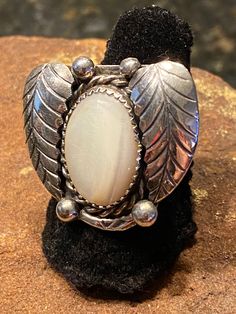 This beautiful Navajo mother of Pearl ring is a size 6 1/2. The saw tooth bezel is surrounded by a rope design and two leaves. It is tested Sterling Silver. No hallmarks. This is typical for vintage Native American Jewelry. Vintage Concho Ring Jewelry, Vintage Handmade Moonstone Ring For Collectors, Vintage Adjustable Concho Rings, Turquoise Belt, Horse Ring, Mother Of Pearl Ring, Vintage Native American Jewelry, The Saw, Navajo Rings