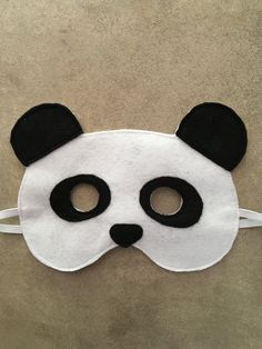 a panda mask with black and white ears