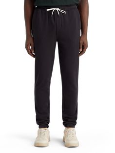 Black Relaxed Fit Sweats With Tapered Leg, Relaxed Fit Sweats With Ribbed Waistband And Tapered Leg, Relaxed Fit Activewear With Ribbed Cuffs And Tapered Leg, Sporty Relaxed Fit Sweatpants For Casual Wear, Comfortable Relaxed Fit Sweatpants For Elevated Casual, Relaxed Fit Sweatpants For Casual Wear, Relaxed Fit Sweatpants With Comfort Waistband For Elevated Casual, Relaxed Fit Sweatpants For Elevated Casual, Relaxed Fit Joggers For Elevated Casual Occasions