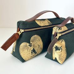 two black and gold bags with hearts on them