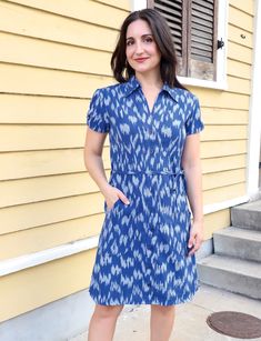 You'll feel regal in our Majestic Cotton Button Dress. Designed in royal blue ikat fabric, this dress boasts a refined collar, a flattering tie waist, and charming gathering at the sleeves. The front buttons add a classic touch, making it the perfect choice for a sophisticated and timeless look that stands out in any setting. Easy-to-open cotton button dress that is great for nursing or pumping mothers. FIT Model is 5'3" and wears S True to size. If in between sizes, size up This fabric does not Casual Fitted Short Sleeve Belted Dress, Casual Fitted Belted Dress With Short Sleeves, Fitted Cotton Shirt Dress With Tie Waist, Blue Belted Button-up Dress, Elegant Spring Dress With Ikat Print, Indigo Dresses For Summer Workwear, Summer Workwear Indigo Dress, Fitted Cotton Belted Dress, Casual Blue Dress With Collared Neckline