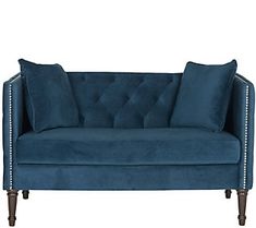 a blue couch with two pillows on it