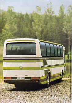 an old bus is parked on the gravel