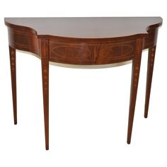 an oval shaped table with two legs and a curved top, in the style of louis ii