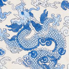 a blue and white dragon design on a linen material with clouds in the sky behind it