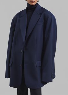 Color: Navy Midweight wool blend fabric Oversized fit Notch lapels Padded shoulders Single illusion front welt pocket Front flap pockets Button cuffs Front button closure Lined 60% Wool 40% Polyamide Dry Clean By The Frankie Shop. Imported Wool Button-up Sport Coat For Work, Navy Single Breasted Outerwear With Suit Collar, Navy Suits For Business Casual In Fall, Wool Business Blazer With Flap Pockets, Button-up Outerwear With Welt Pockets, Wool Blazer With Lapel Collar And Flap Pockets, Business Wool Blazer With Flap Pockets, Wool Blazer With Flap Pockets And Lapel Collar, Wool Blazer With Flap Pockets