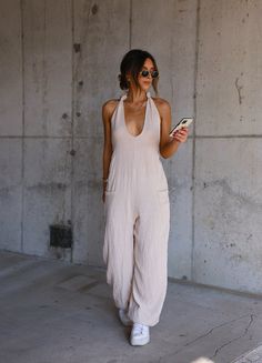 Elevate your fashion game with our Gauze Halter Jumpsuit. Made from 100% cotton with a linen-inspired look, it boasts a tie halter and low cut design. The wide leg creates a flowing silhouette, while front pockets add convenience. Perfect for a casual yet chic ensemble. Fabric 100% cotton Halter Jumpsuit, New Tops, Cut Design, Low Cut, Fashion Games, Business Casual, American Girl, New Dress, Wide Leg