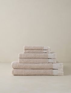 five folded towels stacked on top of each other