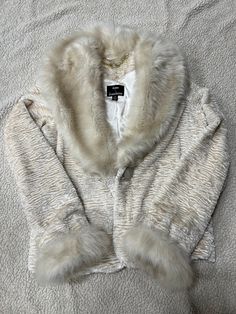 Beautiful cream colored faux fur jacket.  Size X-Small but it does run large. See pictures for details. JKs Cozy White Fur Coat With Faux Fur Lining, Winter White Faux Fur Coat, Cream Fur Coat With Faux Fur Lining, Cream Long-sleeved Fur Coat For Winter, Winter White Fur Coat With Faux Fur Trim, Cream Faux Fur Coat With Faux Fur Lining, Cream Long Sleeve Fur Coat For Winter, Fitted Winter White Faux Fur Coat, Winter White Fitted Faux Fur Coat