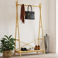 Clean up your closet and easily pick out your outfit with this clothes rack! Durable and long-lasting: As a natural material, bamboo boasts good breathability and a low odor. These qualities make the clothes rack durable, water-resistant, and long-lasting. Ample storage space: The coat rack with shelf has plenty of room for organizing your clothes and bags. The lower shelf is great for boxes and folded clothes or shoes. Stylish and compact design: The clean lines and minimalist design make the free standing coat rack blend into your room perfectly. The clothes stand is also perfect for small rooms due to its compact size. Warning: To prevent it from tipping over, this product must be used with the provided wall attachment device. Size: 40.2" x 19.7" x 74.8".  Age Group: adult. Bamboo Clothes Rack, Bamboo Bedroom, Free Standing Coat Rack, Bamboo Clothes, Folded Clothes, Coat Rack Shelf, Shoes Stylish, Standing Coat Rack, Clothes Stand