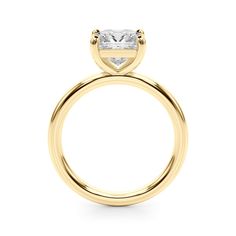 a yellow gold engagement ring with a princess cut diamond