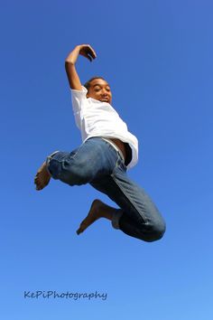 a man jumping in the air with his hands up