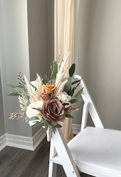 a bouquet of flowers sitting on top of a white chair