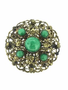 An antique costume green Czech Glass Brooch Pin unknown Metal filigree in excellent Condition throughout measuring 4cm x 4cm All pieces are unique I aim to provide you with a 5 star service and customer satisfaction is my priority. You can purchase with confidence we are here to assist you. All my items are vintage and pre owned so at times they will have signs of age but I try my very best to describe them with accuracy. Your purchase will be carefully packed to protect it. If you wish it wrapped as a gift for someone then do let me know please. SHIPPING U.K.POSTAGE: FREE SHIPPING  Royal Mail Special delivery INTERNATIONAL SHIPPING  FREE SHIPPING WORLDWIDE  ROYAL MAIL I SHIP TRACKED SIGNED AND INSURED BUT IT DOES NOT COVER CUSTOM CHARGES IN YOUR COUNTRY. Collectible Art Nouveau Filigree Brooches, Art Nouveau Filigree Brooch For Collectors, Green Art Nouveau Wedding Brooches, Victorian Green Collectible Brooches, Victorian Round Brooches With Intricate Design, Ornate Round Brooch With Intricate Design, Ornate Filigree Brooches For Collectors, Ornate Round Brooches With Intricate Design, Antique Round Brooch With Intricate Design