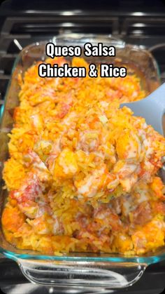 mexican chicken and rice casserole in a glass dish with a white serving spoon