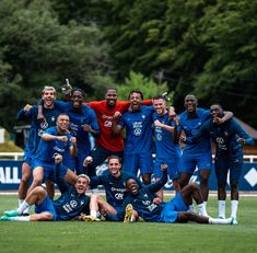 a group of men standing on top of a soccer field