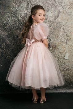 Petite Adele This tea-length girls' dress features organza bubble sleeves, a glitter bodice, and a luxurious tulle skirt. Add an optional satin bow for an unforgettable look! The dress is fully lined and includes additional netting under the skirt to give it an extra fluffy look! Includes a satin waistband to ensure a perfect fit. Dress With Organza, Rose Gold Dress, Under The Skirt, Organza Sleeves, Glitter Top, Kids Fashion Dress, Play Tent, Girls Boutique, Kids Play