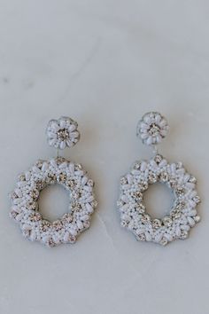 We love these beautifully hand beaded circular style earrings with pearl and crystal details. A statement earring that is beaded on to leather making it super light and comfortable! FINAL SALE Elegant White Embellished Earrings, Elegant Embellished White Earrings, Elegant Beaded Circle Earrings, White Embellished Earrings For Party, Chic Beaded Drop Earrings Jewelry, Elegant Round Beaded Crystal Earrings, Elegant Beaded Round Crystal Earrings, Chic White Beaded Earrings, Untamed Petals