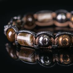 "This bracelet is so cool and luxury, because it is handmade bracelet made with gemstones. ✔ Materials - blue tiger eye - black metal crowns - tiger eye - agate Botswana tube beads -hematite 10 mm - jewelry cord Women's standard size is 6.5'' Men's - 7.5\" You can order bigger or smaller size. This bracelet not only nice accesorie, but it is an amulet, which will bring you good luck and health. This bracelet protects against the evil eye and negative energy. Wrapped in a jewelry box as in the pi Mens Crown, Crown Bracelet, Eye Agate, Blue Tiger Eye, Metal Crown, Blue Tiger, Blue Tigers Eye, Braided Bracelet, Protection Bracelet